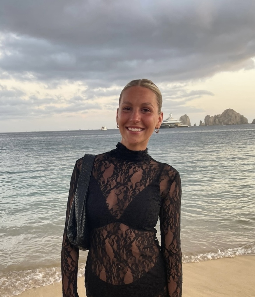 Olivia Hertzog in a black dress on the beach